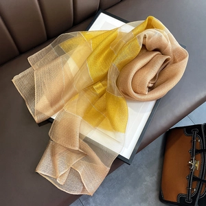Detailed texture of semi-transparent silk blend scarf with yellow geometric pattern