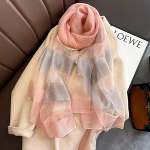 Elegant pink and grey contrast silk blend long scarf draped over a classic wool coat