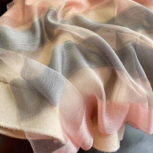 Detail of soft pink and beige striped silk blend scarf with subtle metallic sheen texture