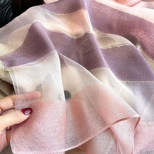Macro detail of silk blend scarf with pink and purple stripes and shimmering metallic threads