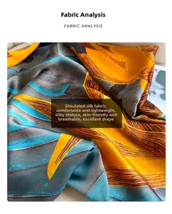 Vue détaillée du tissu soyeux de l'écharpe avec motifs abstraits orange et bleu de peinture