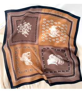Detailed view of paisley and floral patterns on a silk scarf over a light shirt