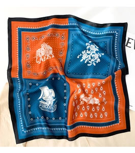 Detail of silk scarf showing vintage paisley patterns with elephant and carriage prints