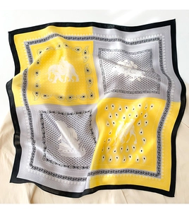 Detailed texture of silk square scarf featuring yellow and grey cashew flower patterns