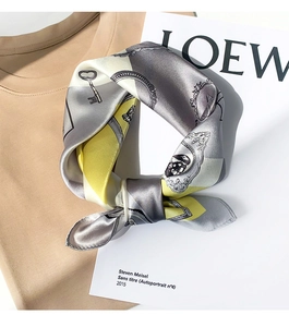 Detail of silk scarf showing vintage key patterns and luxurious satin texture