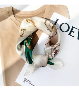 Detail of vintage European silk scarf with golden keys and heraldic prints on cotton tee