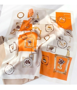 Macro view of vintage silk scarf showing artistic hand-painted illustrations and silk texture