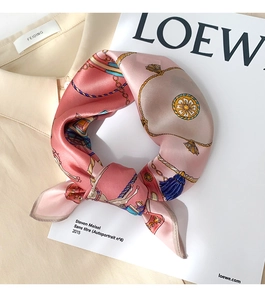 Detailed view of luxury silk scarf with vintage equestrian print on a beige shirt