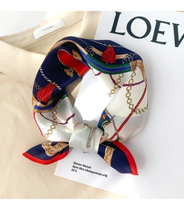 Detailed view of silk square scarf featuring retro carriage chains and red tassels print