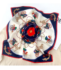 Detail of silk scarf with vintage horse carriage patterns and smooth satin texture