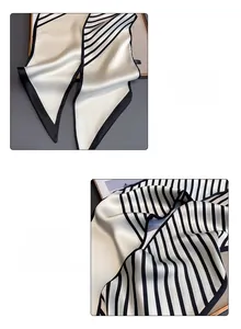 Detail of the stitched hem and geometric black and white striped pattern on the silk scarf