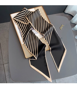 Detail view of striped silk scarf with elegant beige reinforced edges and pointed ends