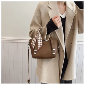 Brown lychee leather bucket bag with houndstooth scarf handle and silver hardware detail
