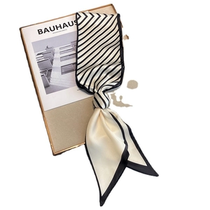 Elegant striped faux silk scarf featuring black and white diagonal patterns and beige tones