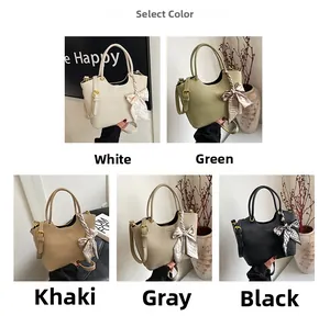 Litchi pattern faux leather texture and silk scarf handle detail on bucket bag