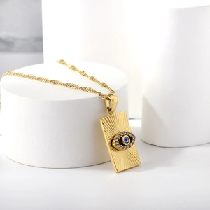 Collier vintage français doré avec pendentif rayon de soleil et œil bleu sur socle