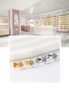 Detailed view of star-shaped stud earrings set with sparkling zircon in gold and silver