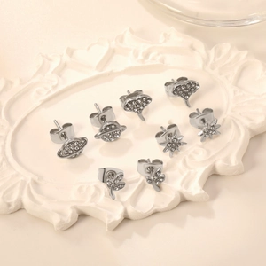 Elegant 4-pair silver stud earring set with sparkling rhinestones in a vintage tray