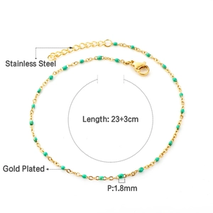 Detail of gold plated stainless steel anklet with green beads and lobster clasp