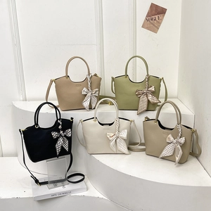 Fashionable bucket bags in multiple colors with silk scarves and litchi grain leather