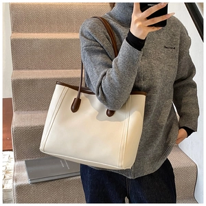 Detail view of the cream large tote bag with dark brown contrast straps for daily commute