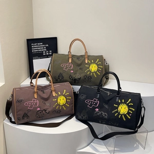 Canvas travel bags with sun and doodle prints in army green, brown, and black