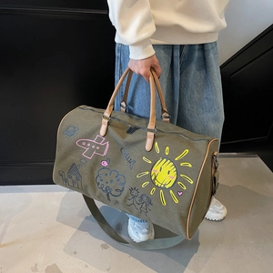 Large olive green canvas travel duffel bag with colorful hand-painted patterns and leather handles
