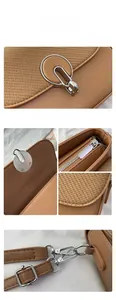 Detailed macro view of silver hardware buckle and fabric texture on a brown crossbody bag