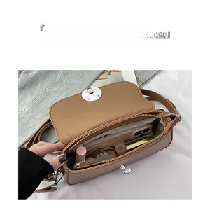 Detail view of large capacity interior and compartments in a brown leather handbag