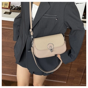 Detail of crossbody bag with beige woven flap, leather body and silver metallic buckle