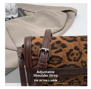 Detailed close-up of the leopard print fabric texture and adjustable leather strap buckle