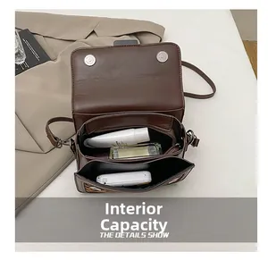 Internal capacity of leopard print crossbody bag with multiple compartments and magnetic buckle