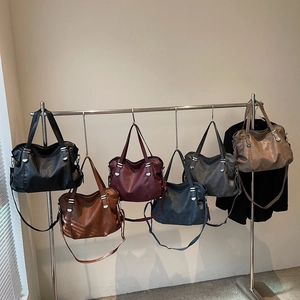 Retro faux leather tote bags in six colors hanging on a rack for fashion display
