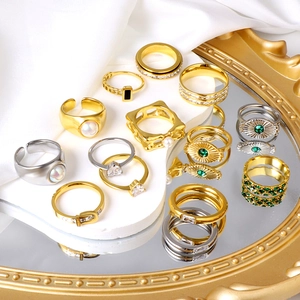 Chic multi-style gold and silver ring set with pearls and crystals on a mirror surface
