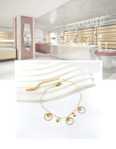 Detailed view of gold-plated anklet with spiral zircon rings and teardrop pendants