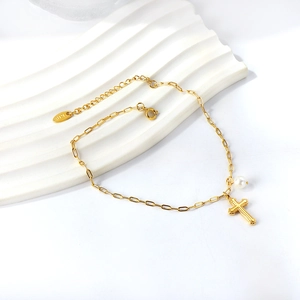 Elegant 18K gold chain anklet featuring a textured cross pendant and a white pearl charm