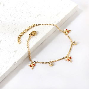 Bracelet en acier inoxydable doré avec breloques libellules rouge blanc et cristaux