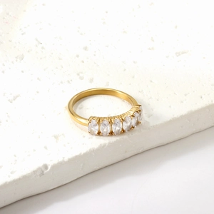Elegant gold-plated ring featuring five oval white zircons on a white textured stone base