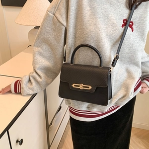 Fashionable black contrast panel handbag with gold chain lock and leather shoulder strap