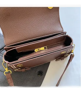 Detail of lychee pattern leather bag interior with smooth zipper and layered compartments