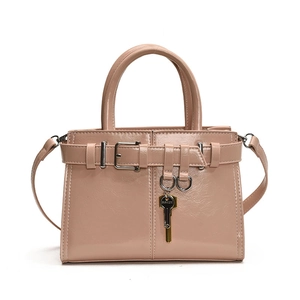 Sac à main en cuir verni rose brillant avec boucle décorative et pendentif clé dorée