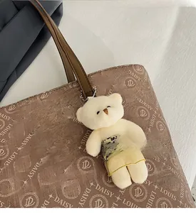 Detail view of brown monogram tote bag with daisy louis print and fluffy bear charm