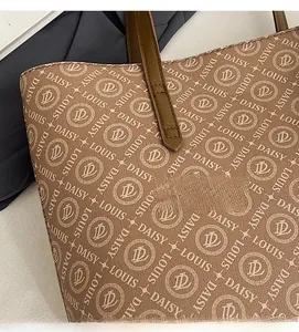 Detailed view of brown letter print fabric and precise stitching on the tote bag