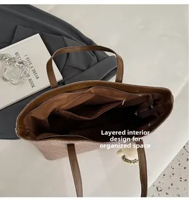 Interior view of large brown tote bag with zipper pockets and layered compartments