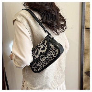 Chic leopard print underarm bag shown on a model with minimalist beige clothing