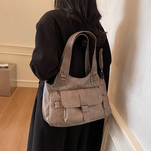 Retro large capacity tote bag in coffee faux leather with multi-pocket design shown on model