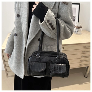 Close-up of black crocodile embossed tote bag with double pockets and silver hardware