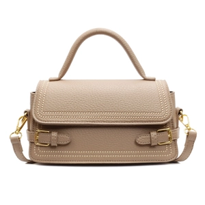 Elegant beige lychee texture leather handbag with gold buckles and detachable strap