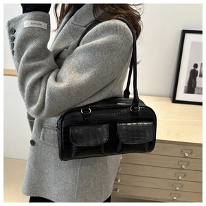 Detail of black faux crocodile leather shoulder bag with dual front flap pockets