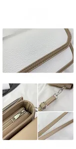 Detail view of contrast color crossbody bag with lychee texture and silver hardware